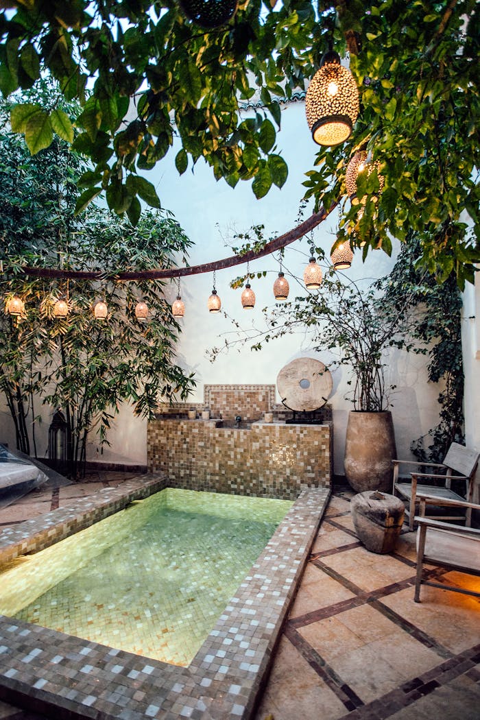 Service 4 Traditional oriental hammam pool on exotic resort spa terrace decorated with lush plants and stylish lanterns